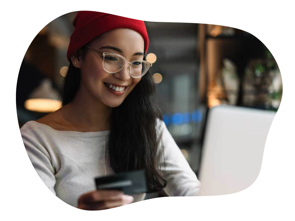 Woman making digital payment with credit card through laptop